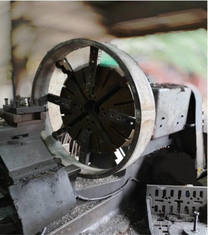Very large ring mounted on faceplate chuck of lathe
