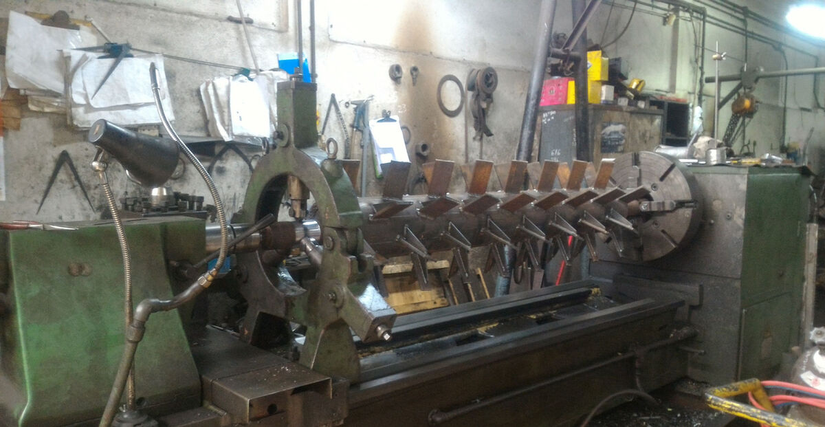 Mixer paddle shaft between centres on lathe